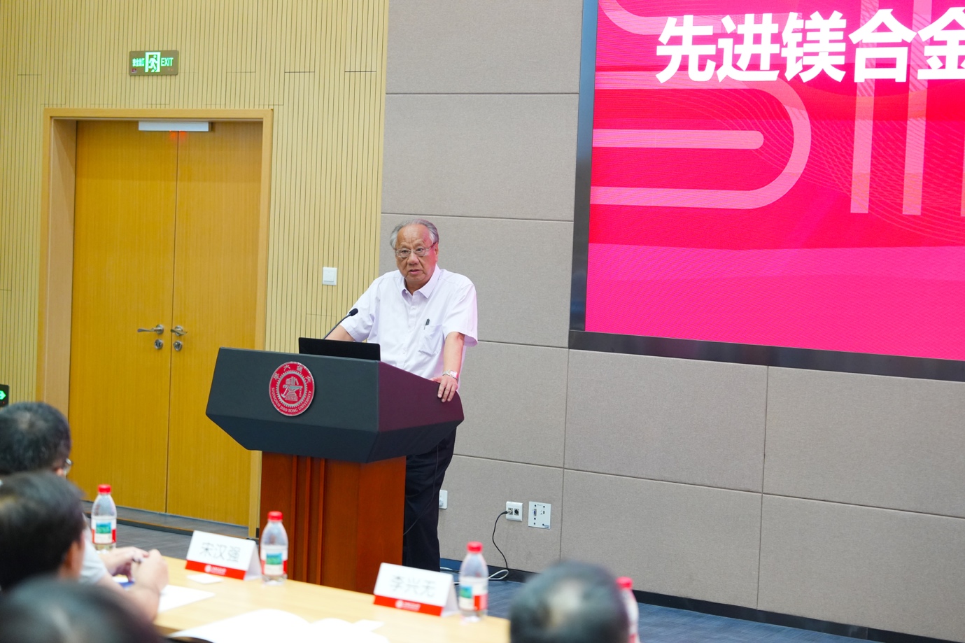 A person standing at a podium

Description automatically generated